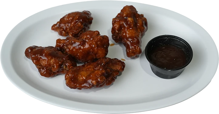 Morales Pizzeria sauced wings on a white oval platter